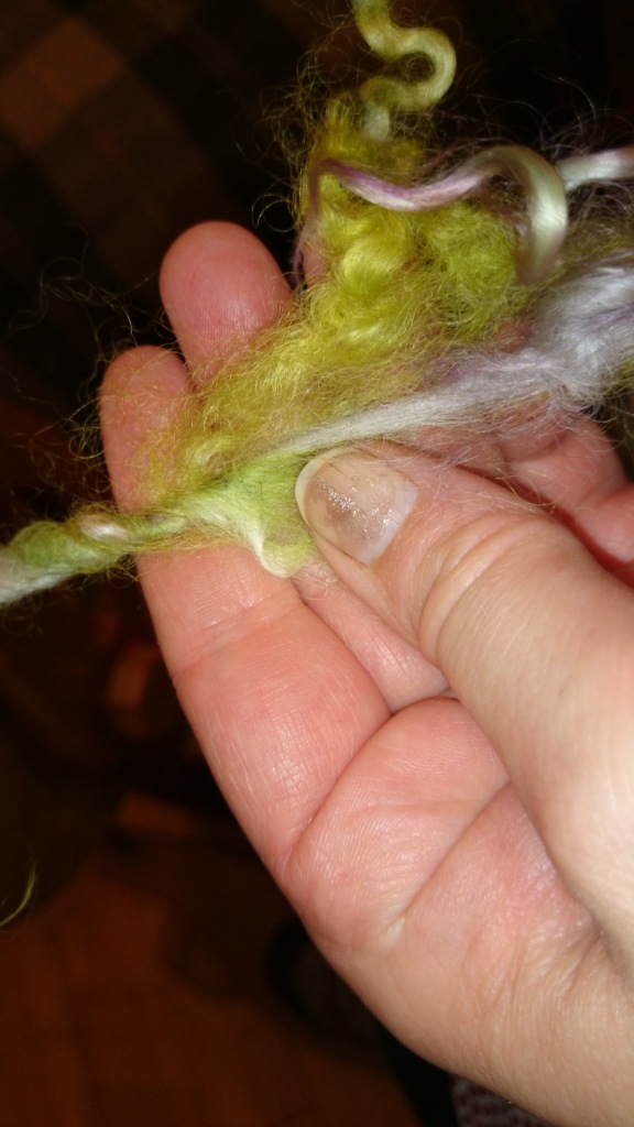 Add the lock by holding at 45 degree angle.  This leaves a tail bit hanging and spices up the bits where locks are scarce, or drafting evened your wool out too much. 